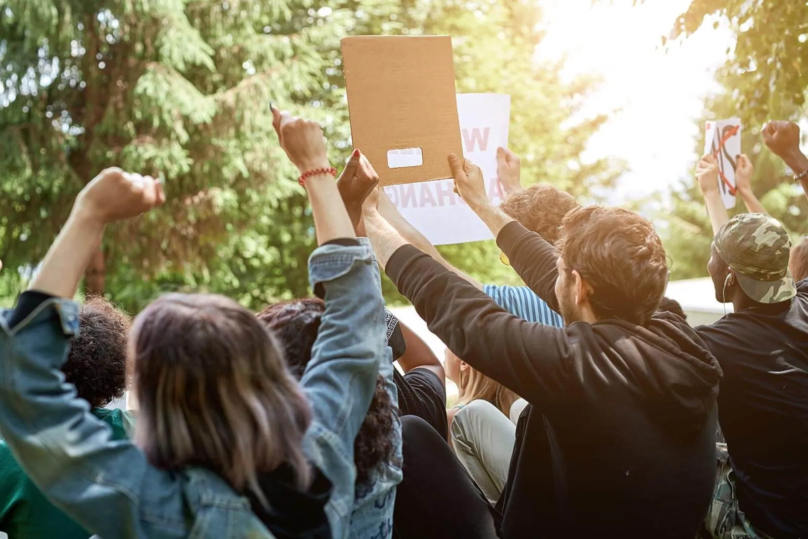 A crowd at a demonstration holding signs