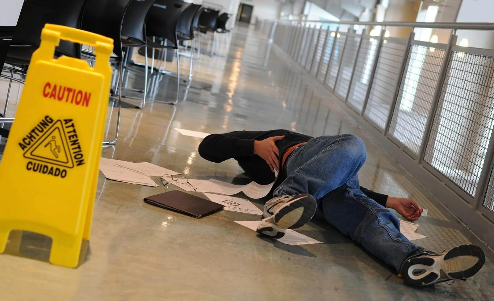A yellow caution sign beside a fall on a polished floor