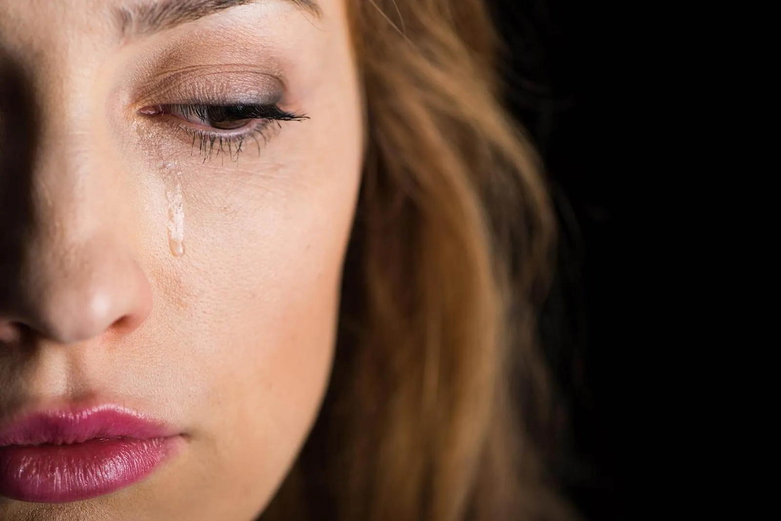 A close view of a woman in tears